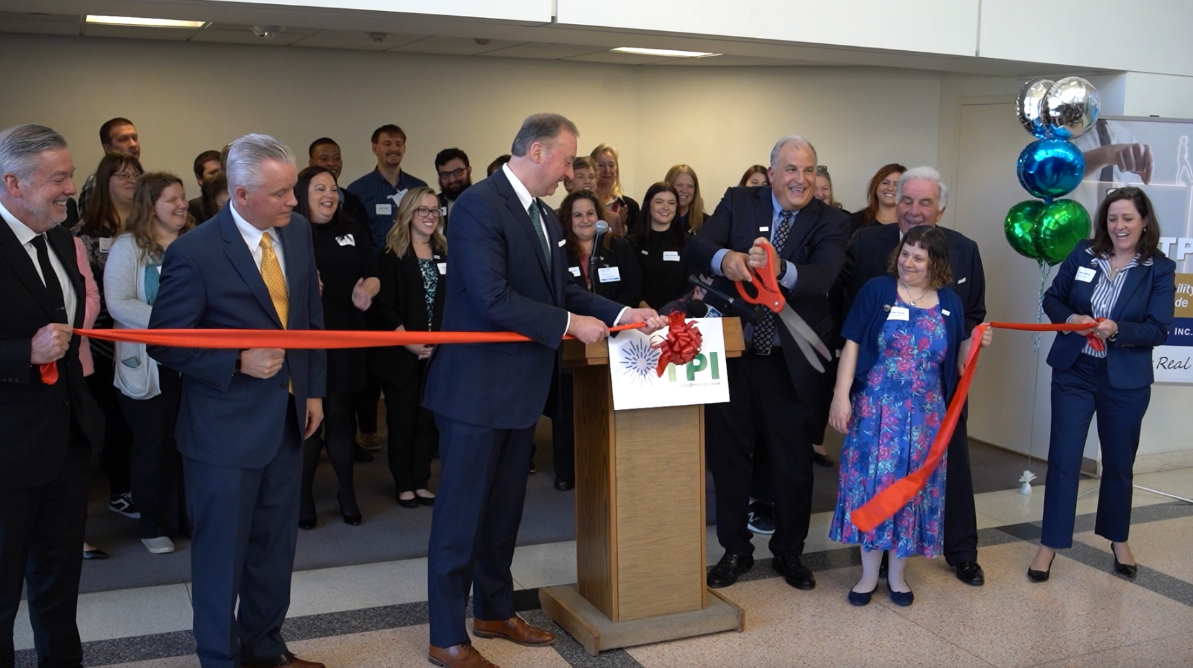 Video: a man behind a video camera with a teleprompter, recording a woman speaking.