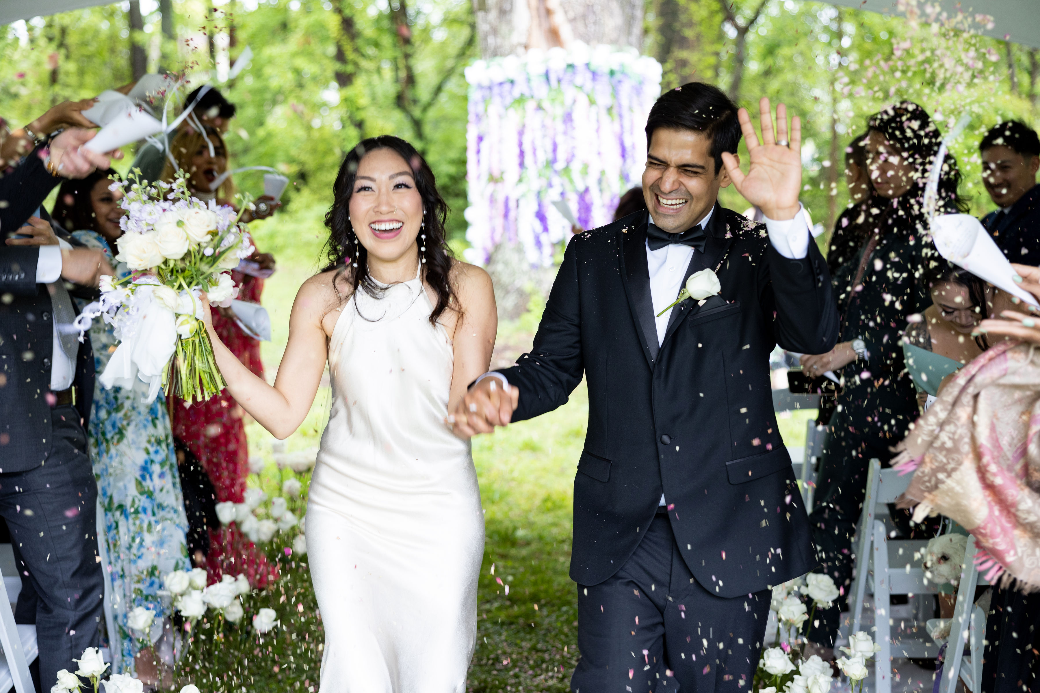Weddings: a man at an event taking a photograph with a professional camera.